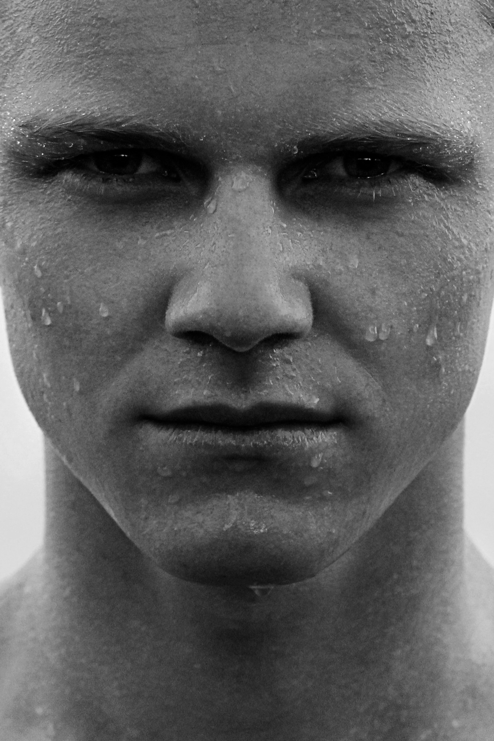 A face straight to camera, wet from cold water